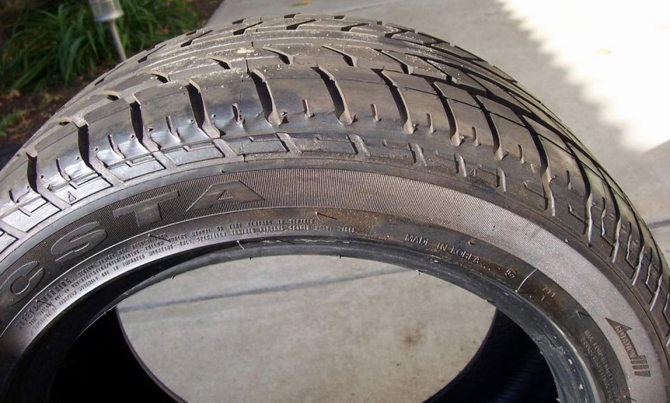 Tire with visible tread pattern and sidewall text