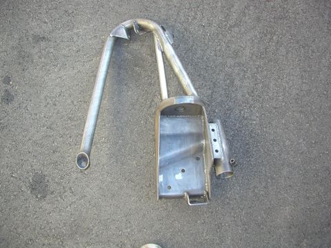 1984 Ford Bronco - Unidentified custom metal fabrication part shown on asphalt ground.