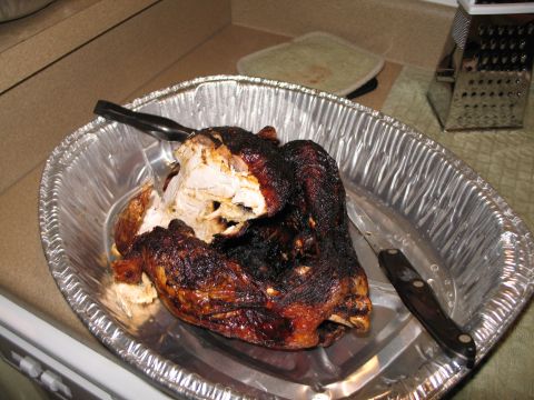 1995 Ford Bronco - A carved turkey sits in a disposable aluminum pan, ready to be served.