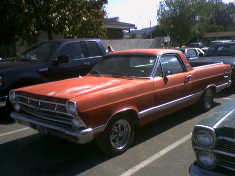 1973 Ford Ranchero - This 1966 Ford Ranchero is parked next to other vehicles in a lot.