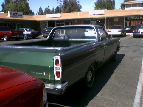 1973 Ford Ranchero - Rear view of a green 1973 Ford Ranchero, showing its distinctive taillights and bed.