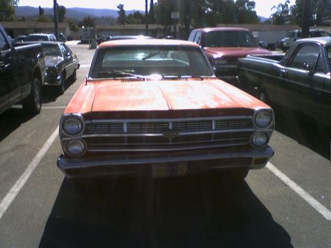1973 Ford Ranchero - This 1966 Ford Fairlane is parked next to other vehicles.