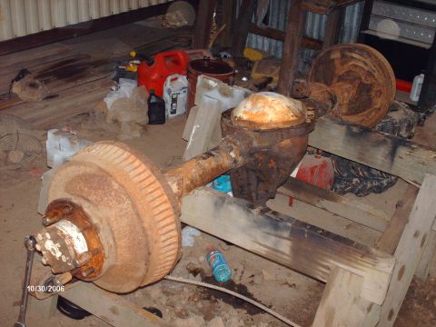 1990 Ford F-150 - A rusty rear axle assembly is shown, not a complete vehicle, contradicting the registry claim.