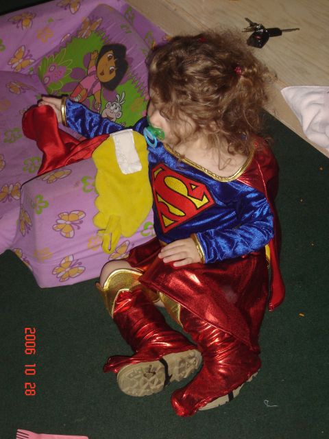 1993 Ford Bronco - Child dressed as Supergirl with a pacifier rests on the floor next to a Dora the Explorer pillow.