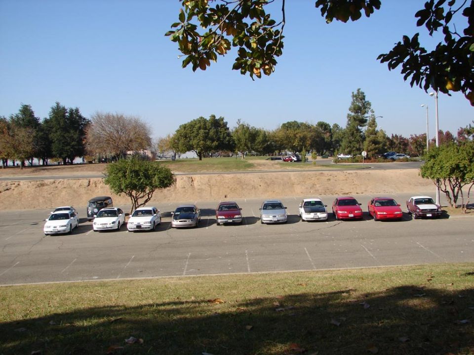 Row of sedans parked in a lot, including a 1992 Ford Taurus