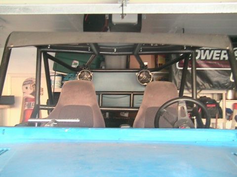 1971 Ford Bronco - Roll cage and interior of a modified off-road vehicle, seen from the front.