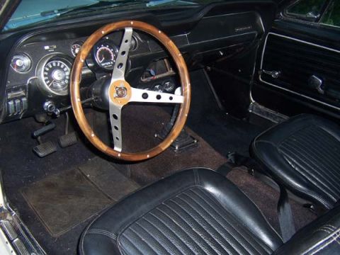 1968 Ford Mustang - Interior view of a 1968 Ford Mustang, showing the dashboard, steering wheel, and seats.