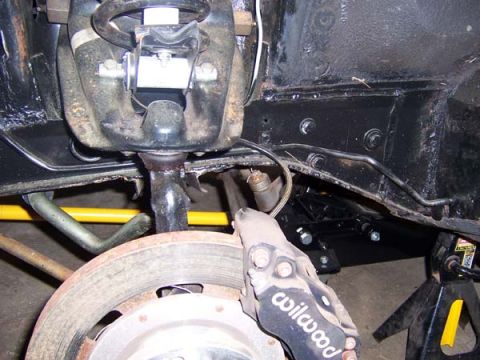 1968 Ford Mustang - Close-up view of the front suspension and brake assembly, showing a Wilwood caliper and suspension parts.