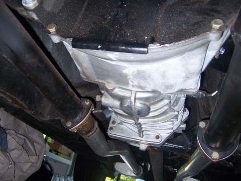 1968 Ford Mustang - Close-up shot of the vehicle's drivetrain components, including the transmission and exhaust system.