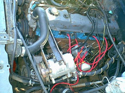 1983 Ford Bronco - i started by removing the bolts that held the compressor in place and the air cleaner and PCV and front oil vent plugs.