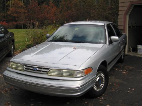 1991 Ford LTD Crown Victoria - A silver 1991 Ford Crown Victoria LTD is parked in a driveway during autumn.