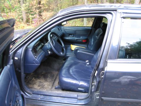 1991 Ford LTD Crown Victoria - The interior of a 1991 Ford Crown Victoria LTD features blue leather seats and a matching dashboard.