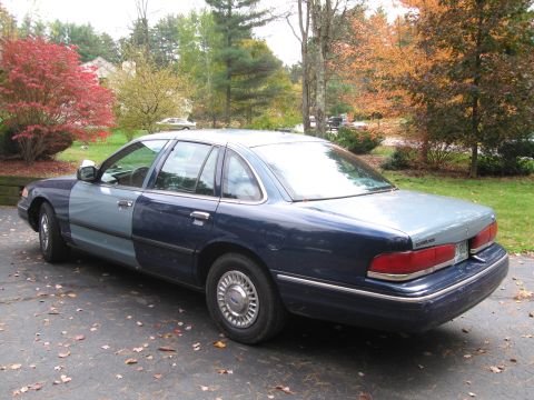 1991 Ford LTD Crown Victoria - Rear view of a two-tone Ford Crown Victoria parked on a driveway in autumn.