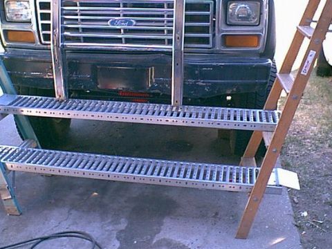 1983 Ford Bronco - the bronco got so tall i needed a work platform to stand on to ork on it.this is my motorcycle ramps and 2 ladders. works great.