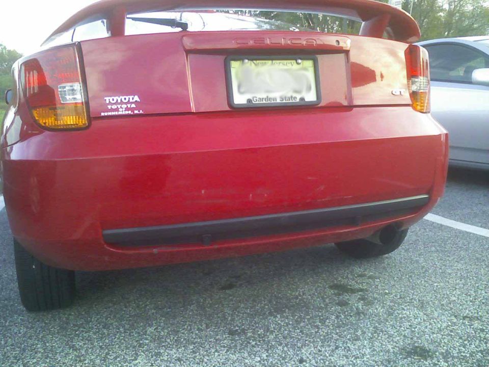 Red Toyota Celica rear bumper with New Jersey license plate and Toyota badging