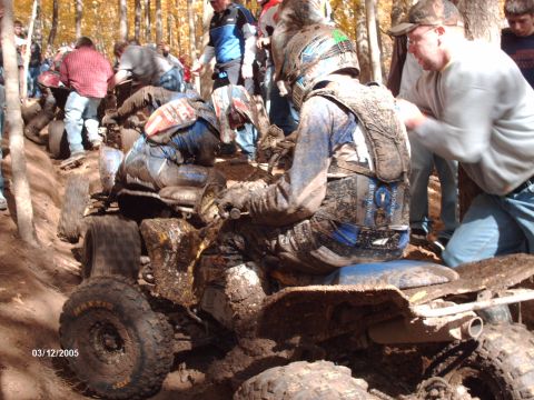 1995 Ford Probe - Riders and their quad bikes navigate a muddy course during an event.