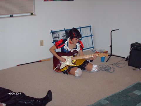 1995 Ford Probe - A person in a costume plays a guitar indoors, with a visible date stamp indicating the photo was taken in 2005.