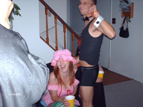 1995 Ford Probe - People in costumes are having fun at a party, with a staircase and decorations visible in the background.