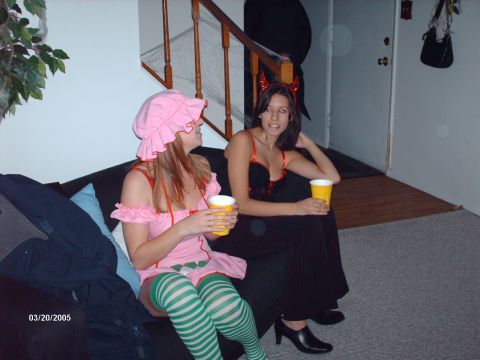 1995 Ford Probe - Two women in Halloween costumes sit on a couch holding drinks, with a date stamp of 03/20/2005 visible.