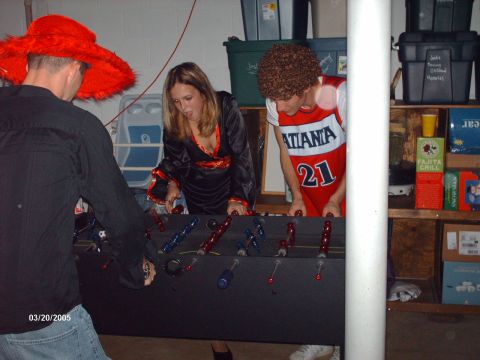 1995 Ford Probe - Friends gather for a game of foosball, dressed in playful costumes, in a casual basement setting.