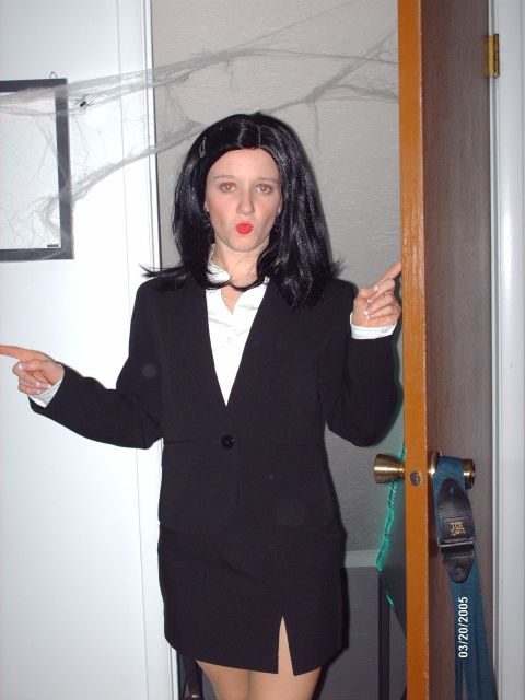 1995 Ford Probe - A woman dressed in a suit and wig, with fake spiderwebs in the background, points in two directions.