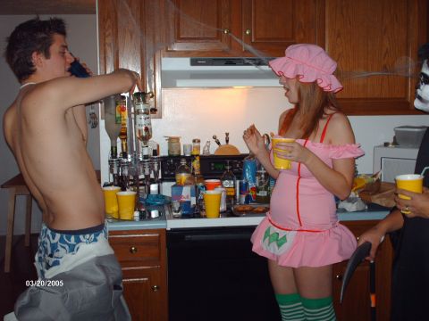 1995 Ford Probe - A group of people are seen in a kitchen, possibly during a Halloween party, with drinks and decorations visible.