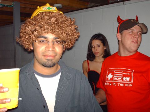 1995 Ford Probe - Three individuals in Halloween costumes pose for a photo at a party, with one person sporting a distinctive wig and hat.