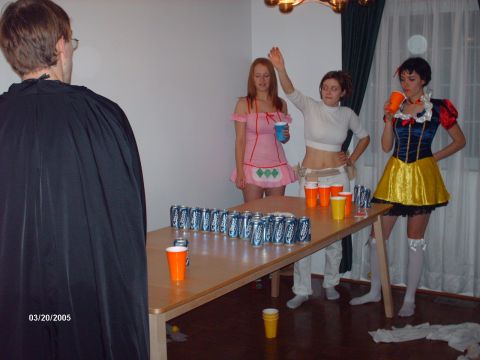 1995 Ford Probe - A group of people in costumes are gathered around a table with drinks during a party.
