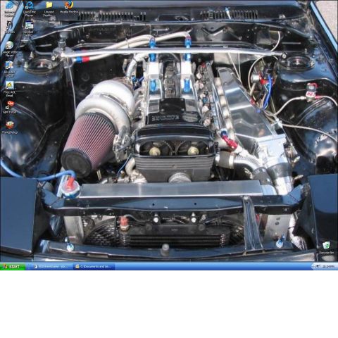 1991 Ford Probe - Customized engine bay with a prominent turbocharger and intercooler system.