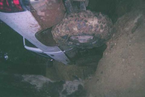 1978 Ford Bronco - This 1978 Ford Bronco appears to be stuck in a muddy ditch, viewed from the side.