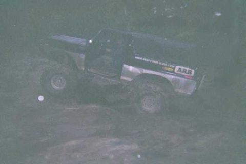 1978 Ford Bronco - 1978 Ford Bronco navigating an off-road trail, with an ARB sticker visible on the side.