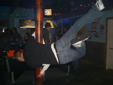 1977 Ford F-150 - Man performs a dance move on a pole inside a dimly lit bar with a pool table visible.