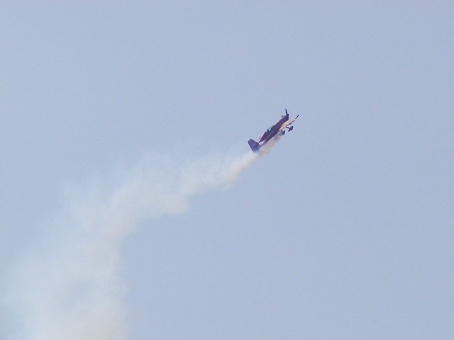 Extra 330XS doing some rolls. This guy did a crazy side-slip landing right from the end of a loop.  He's doing a loop, then suddenly he's on the ground.  Pretty wild.