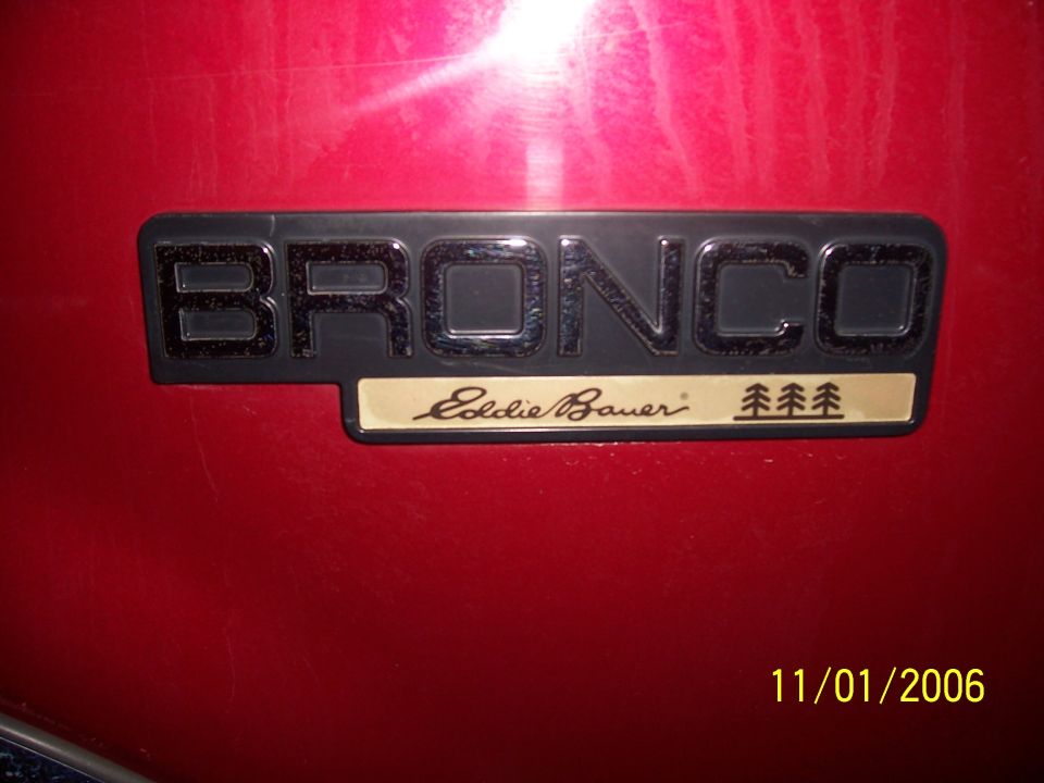 Bronco Eddie Bauer emblem on red vehicle body