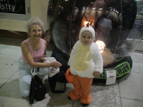 1993 Ford C-350 (Centurion Conversions) - A woman and a child in a chicken costume stand near a Halloween decoration.