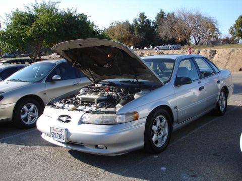 1992 Ford Taurus - Silver 1992 Ford Taurus at a meet, hood is open showing the engine bay.