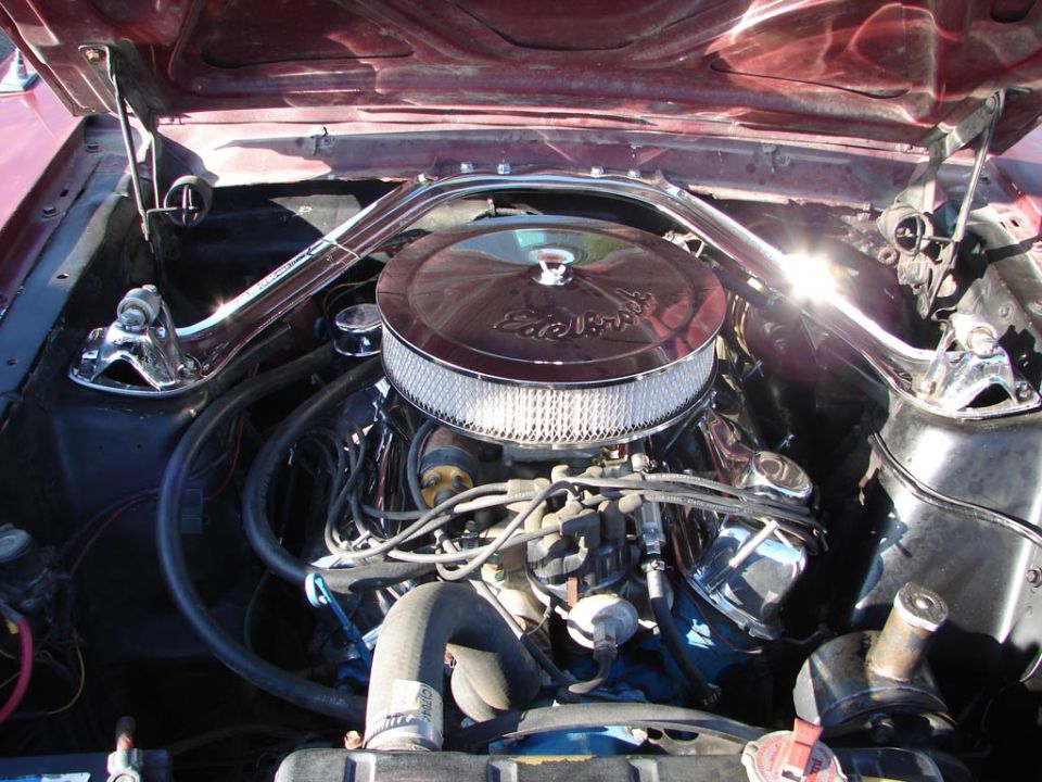 Engine bay with chrome Edelbrock air cleaner and polished strut tower brace