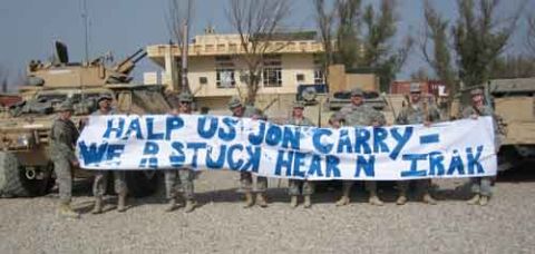 1968 Ford Mustang - Soldiers hold a banner in front of military vehicles, requesting help.