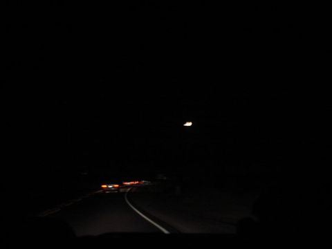 1992 Ford Taurus - View from inside a vehicle driving on a highway at night, with other cars visible ahead.