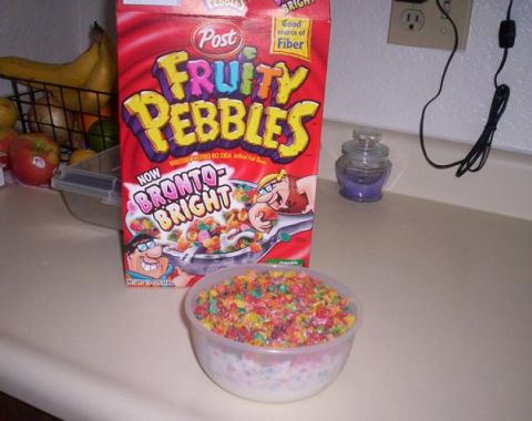 1989 Ford Bronco - A box of Post Fruity Pebbles cereal and a bowl of the cereal with milk on a kitchen counter.