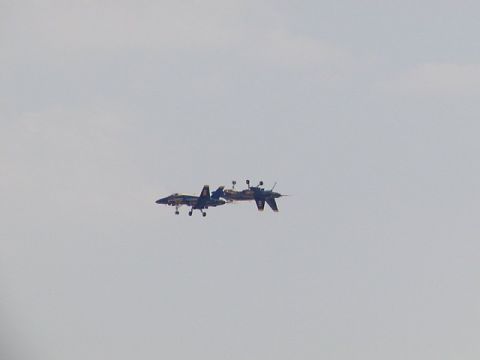1998 Ford Taurus - Two fighter jets perform maneuvers in the sky during an airshow.