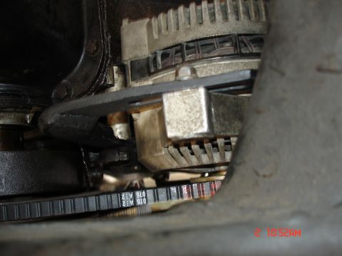 1979 Ford Bronco - Close-up view of an alternator and belt assembly, with visible part numbers on the belt.