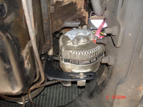 1979 Ford Bronco - Close-up view of an alternator installation, showing the mounting bracket and wiring.