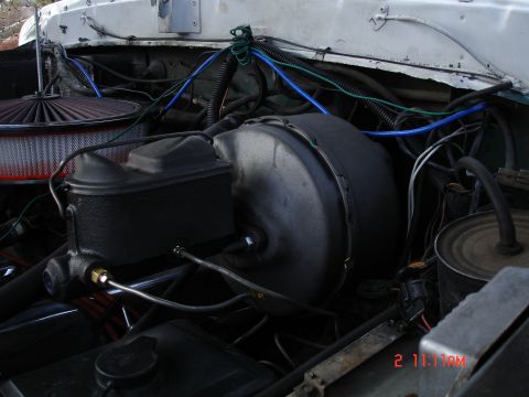 1979 Ford Bronco - Close-up view of the engine bay, focusing on the brake booster and master cylinder assembly.