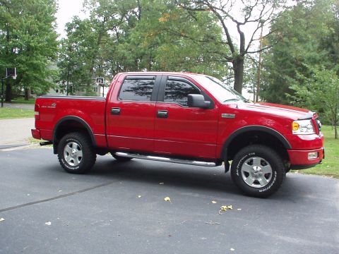 1994 Ford Bronco - This red Ford F-150 pickup truck is shown from a 3/4 front angle, with visible "Supermotors.net" branding at the bottom right.