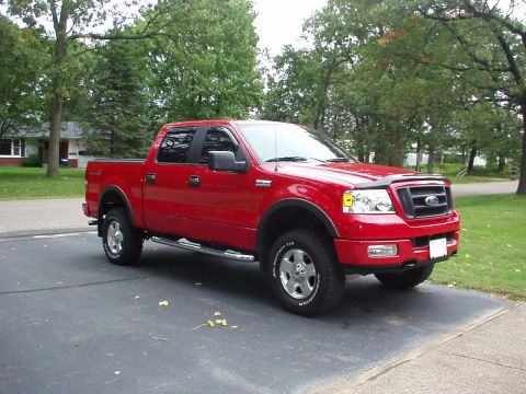 1994 Ford Bronco - Red 2005 Ford F-150 pickup truck with four doors and a short bed.