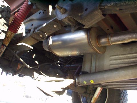 1994 Ford Bronco - Underside view shows the exhaust system, driveshaft, and suspension components of a vehicle.