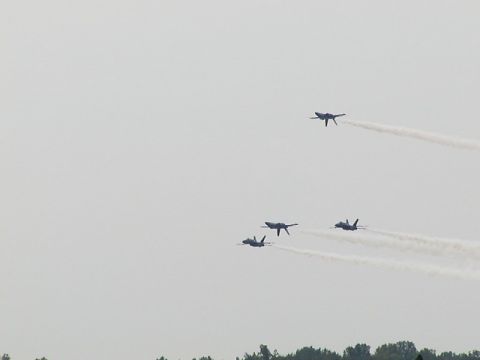 1998 Ford Taurus - Airplanes performing a flyover at an airshow, leaving visible smoke trails.