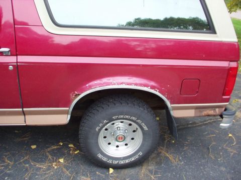1994 Ford Bronco - Rear side view of a 1994 Ford Bronco, showing the wheel well and quarter panel.