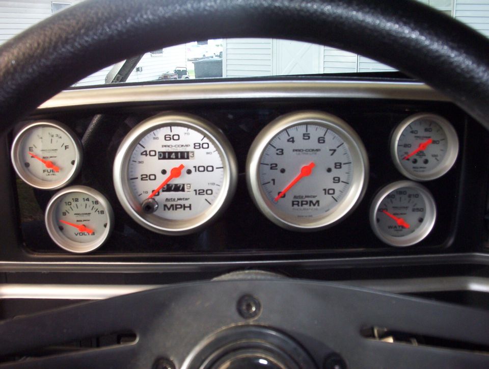 Dashboard gauges with tachometer, speedometer, fuel, and voltage meters
